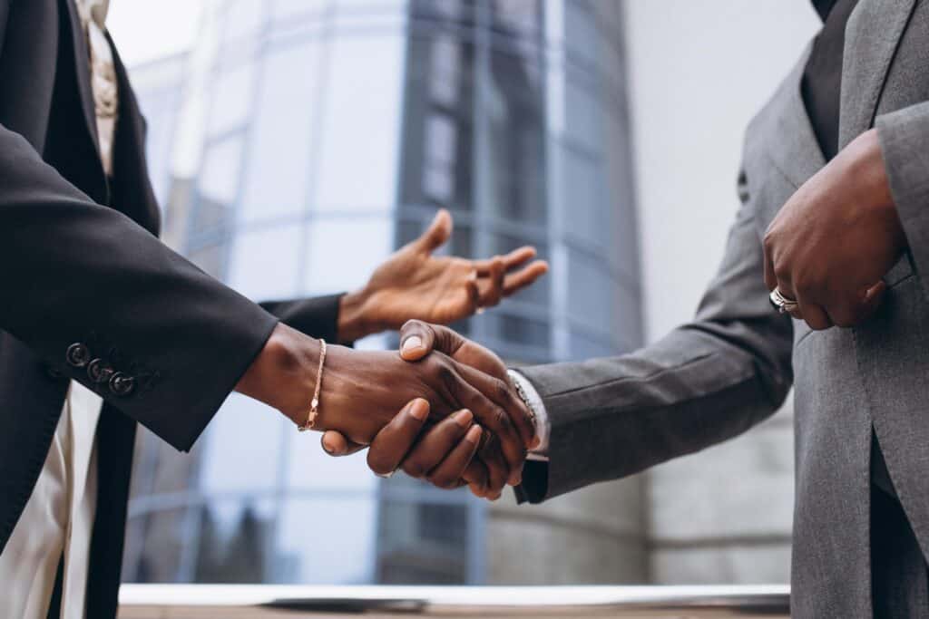 photo of two professional give each other a handshake
