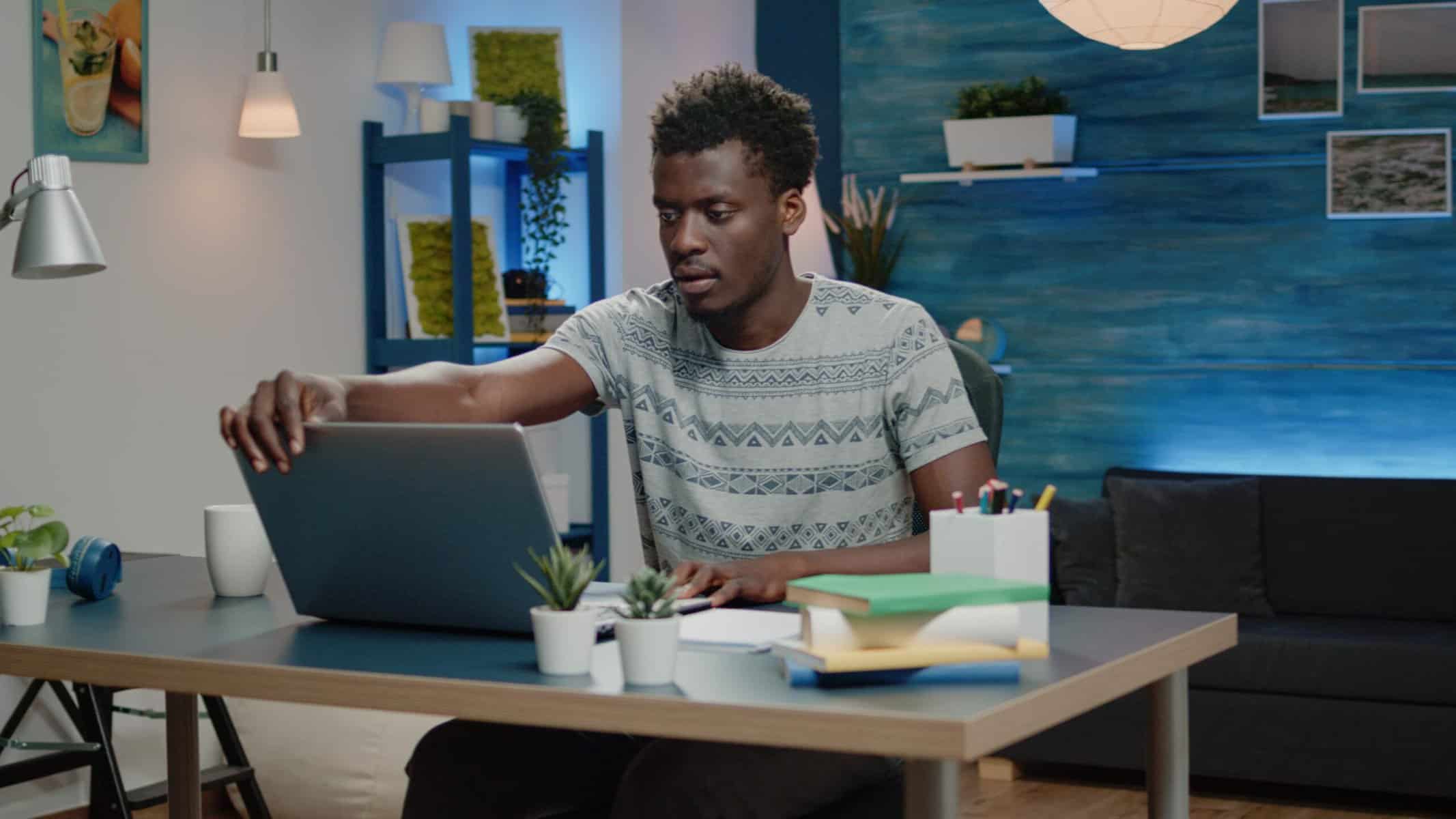 a black guy working on a laptop